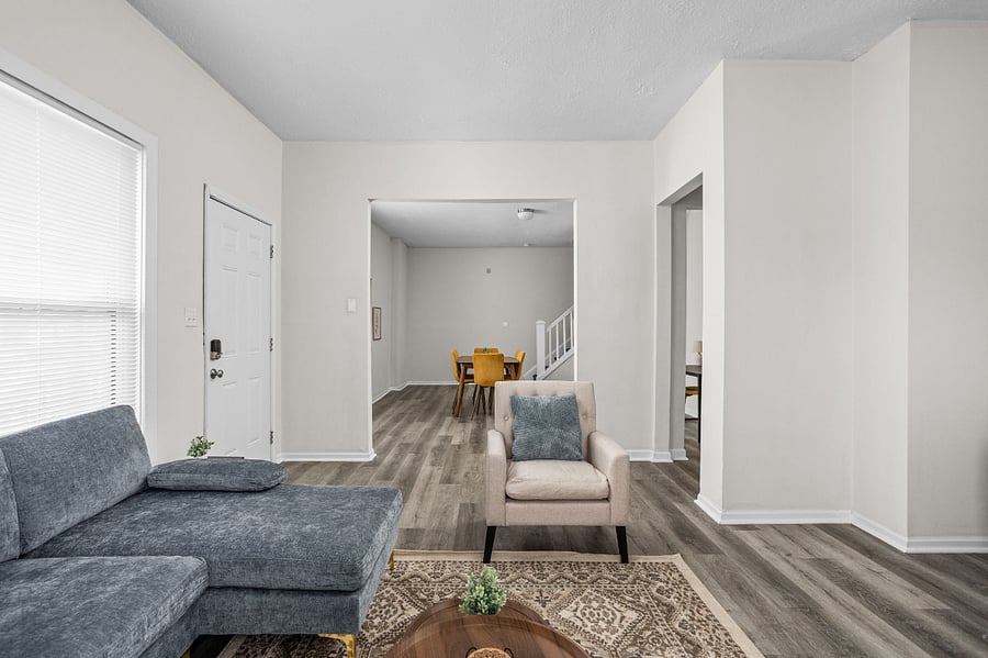 Spacious open-concept living area with modern decor and natural light.