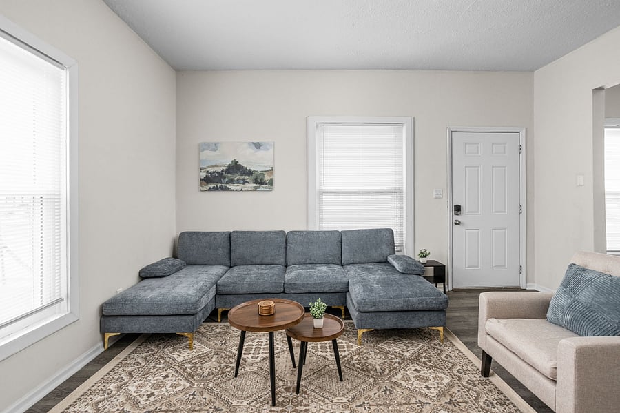 Stylish and cozy living room with a modern sectional sofa, neutral tones, and elegant decor.