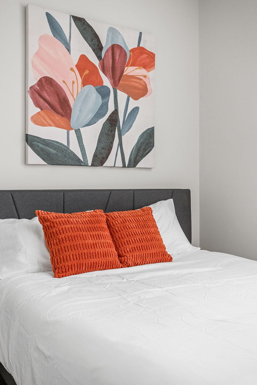 Modern bedroom with a pop of color for a warm and inviting feel.