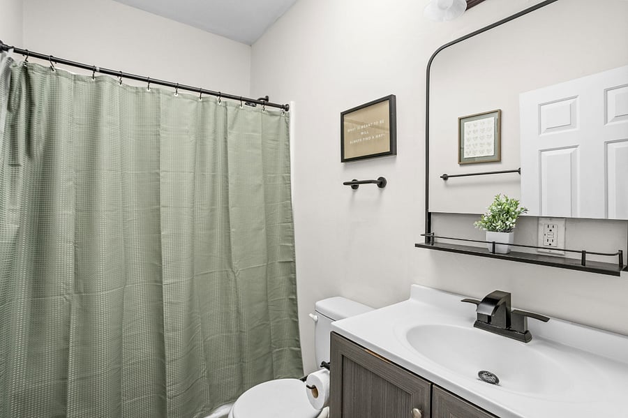 Modern and stylish bathroom with a calming green touch.