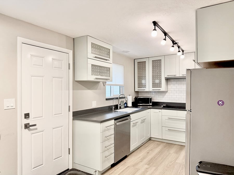 Fully Equipped Kitchen, backdoor to the fully fenced backyard and detached garage.