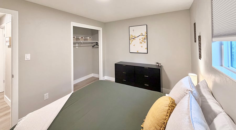 Queen Bed, dresser, closet and blackout shades in an upstairs bedroom.