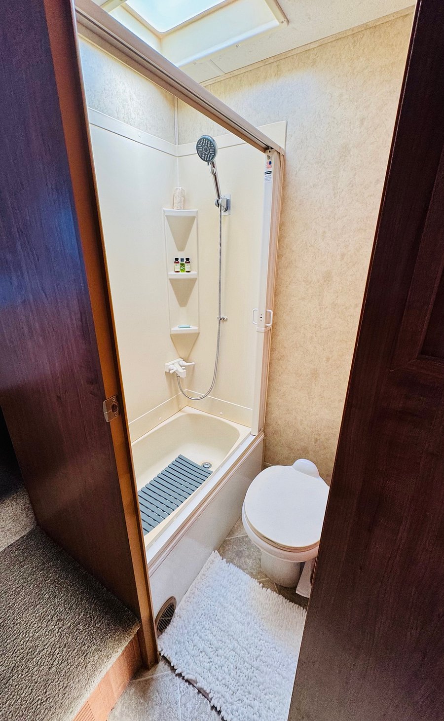 Bathroom with storage cabinet, tub and shower
