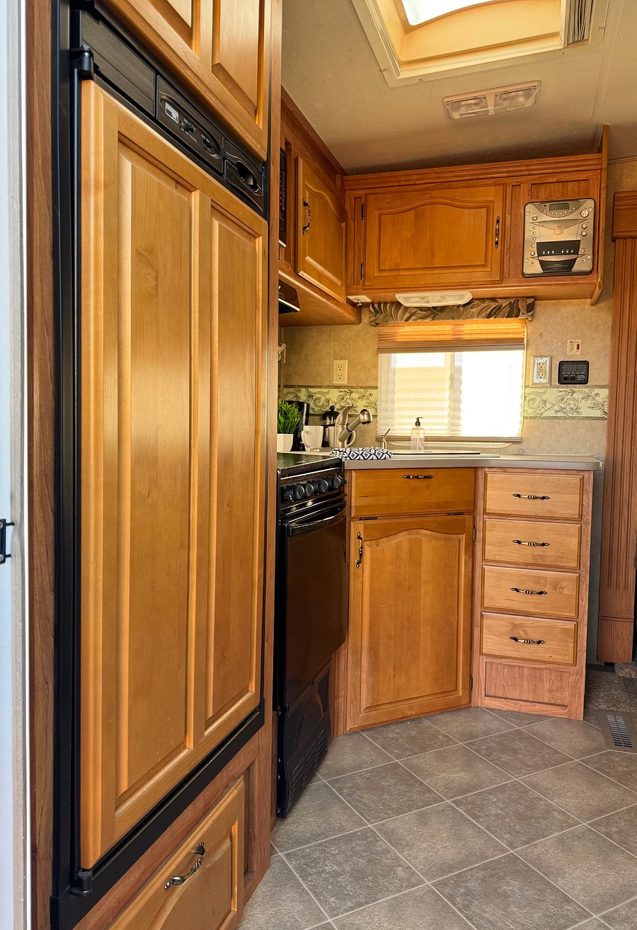 medium size fridge with freezer in kitchen