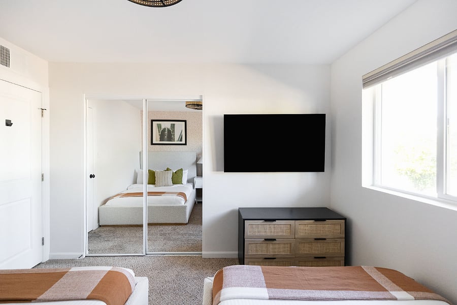 Bedroom - 2 full beds, 55" TV, fan, & closet
