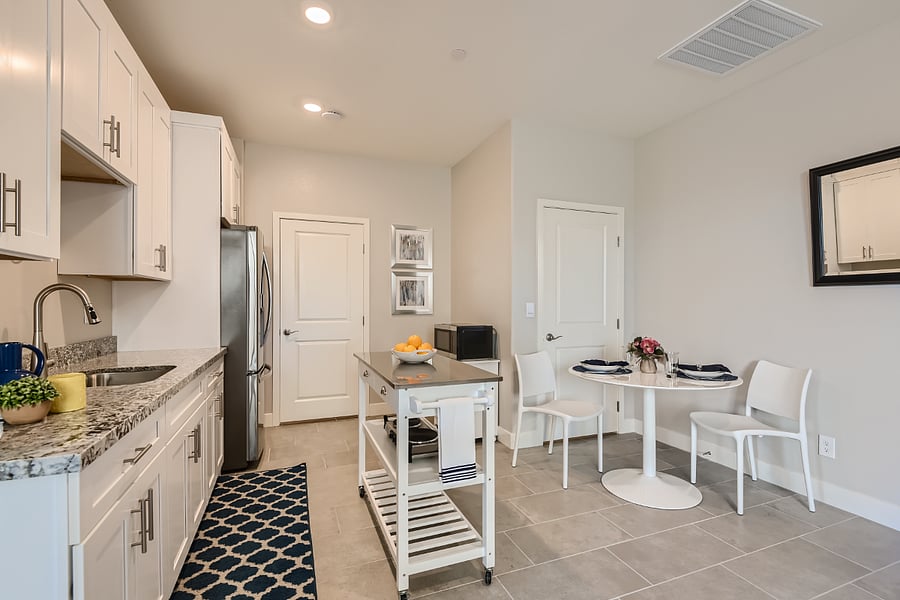 Kitchenette and dining area. The door on the left is your private laundry and pantry. The door on the right is the connection to the main part of the home, and remains locked from both sides.
