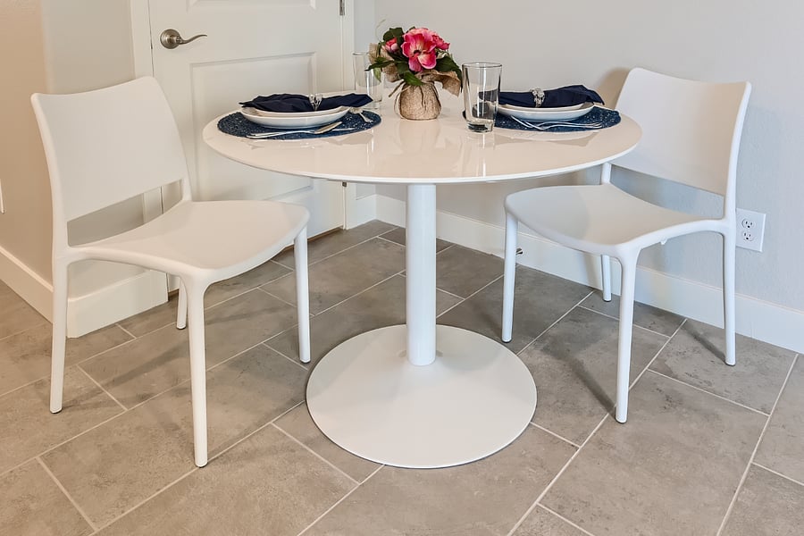 Sturdy table and chairs with set of 4 place settings, including flatware and drinkware.