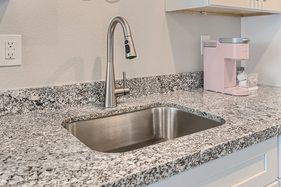 Undermount sink with garbage disposal.