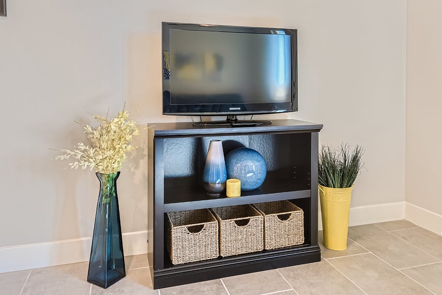 TV with decorative storage baskets, empty for your use.