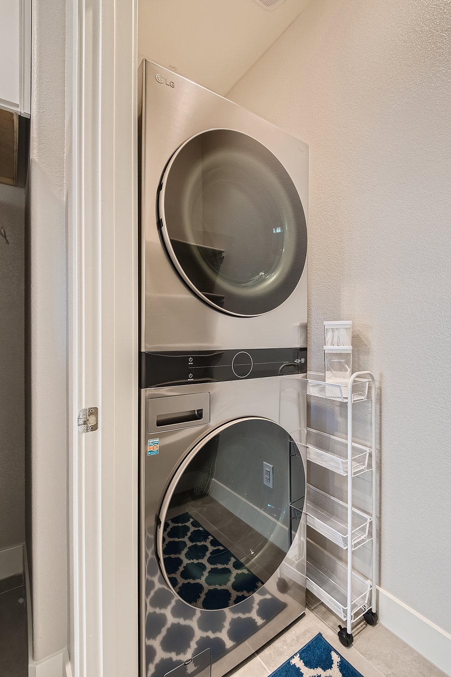 Full size washer and dryer tower. Little rolling cart to conveniently store your laundry products separate from the pantry side.