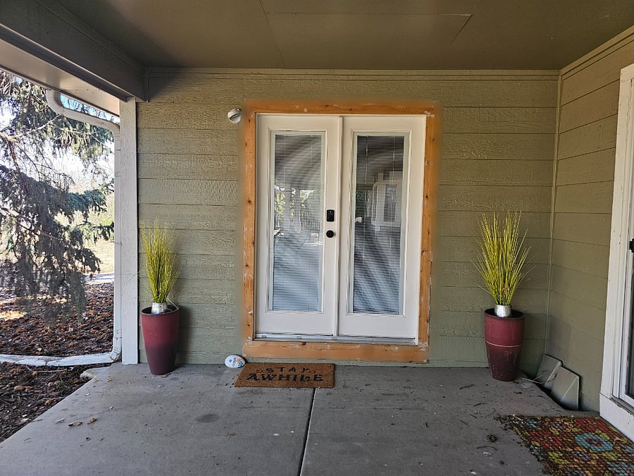 Front entrance is located under a covered patio.