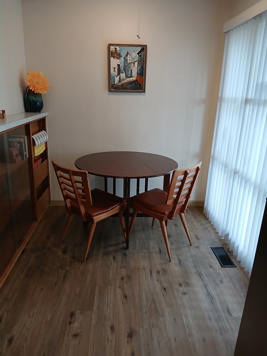 A separate front entrance room with a sitting area and table.