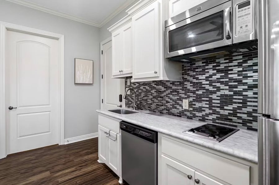 Kitchen with microwave, dishwasher, stovetop