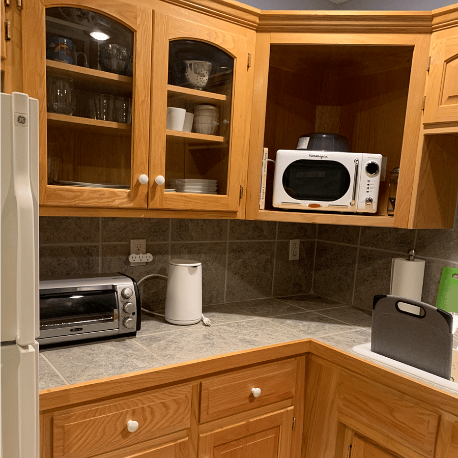 Kitchenette doesn't have a range. Includes toaster oven, microwave, and electric skillet, as well as cookbooks for cooking with these appliances.