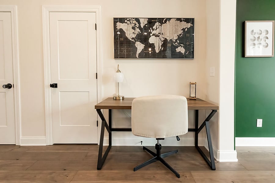 Full size desk with crisscross office chair and desk lamp.
