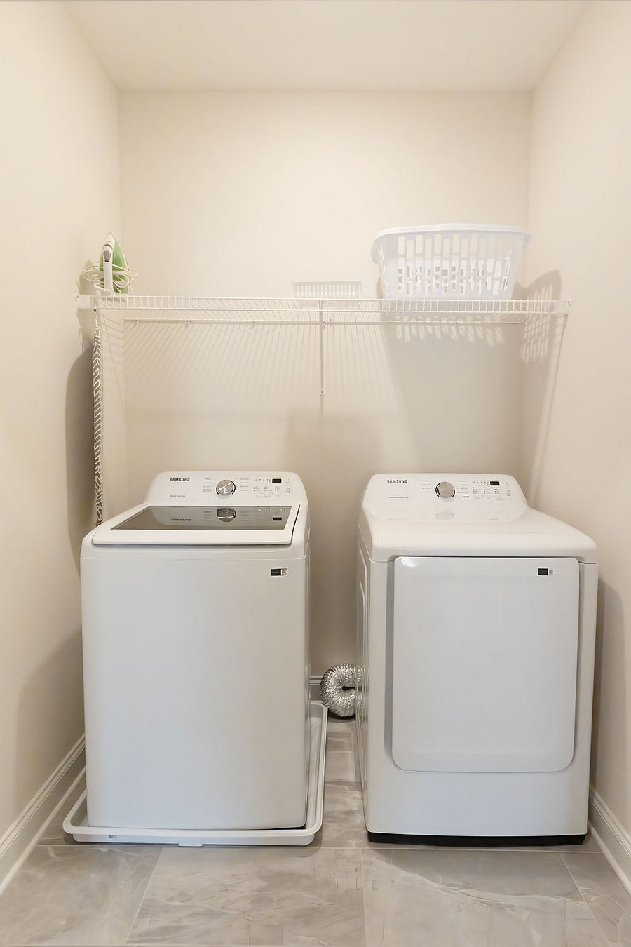 Full size washer and dryer upstairs with iron and ironing board