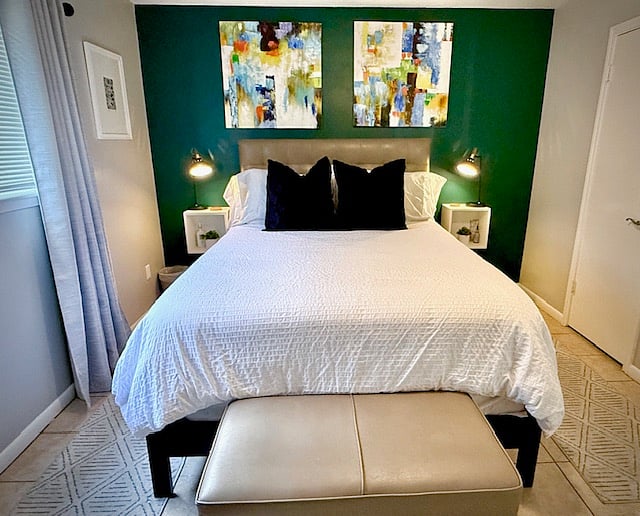 The green color accent wall is very calming and the artwork hanging above the bed is from a local Houston artist.
The side "tables" are floating to keep the room feeling open and airy.