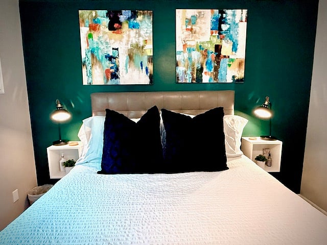 The bed is from West Elm it has a top-grain leather headboard. The foot of the bed has a bench making dressing easy & quick in the mornings.