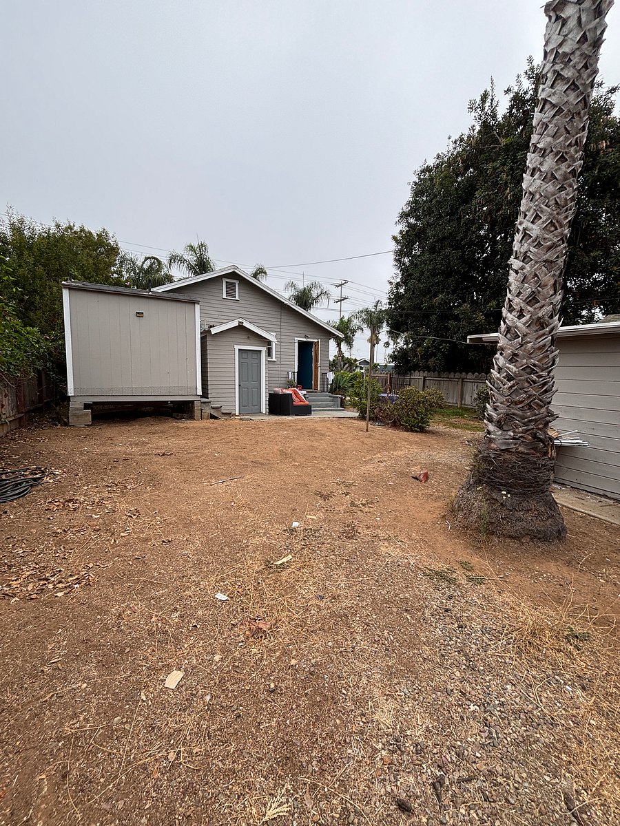 View of house from back gate. Plenty of room to park a car (or two) within the gated yard
