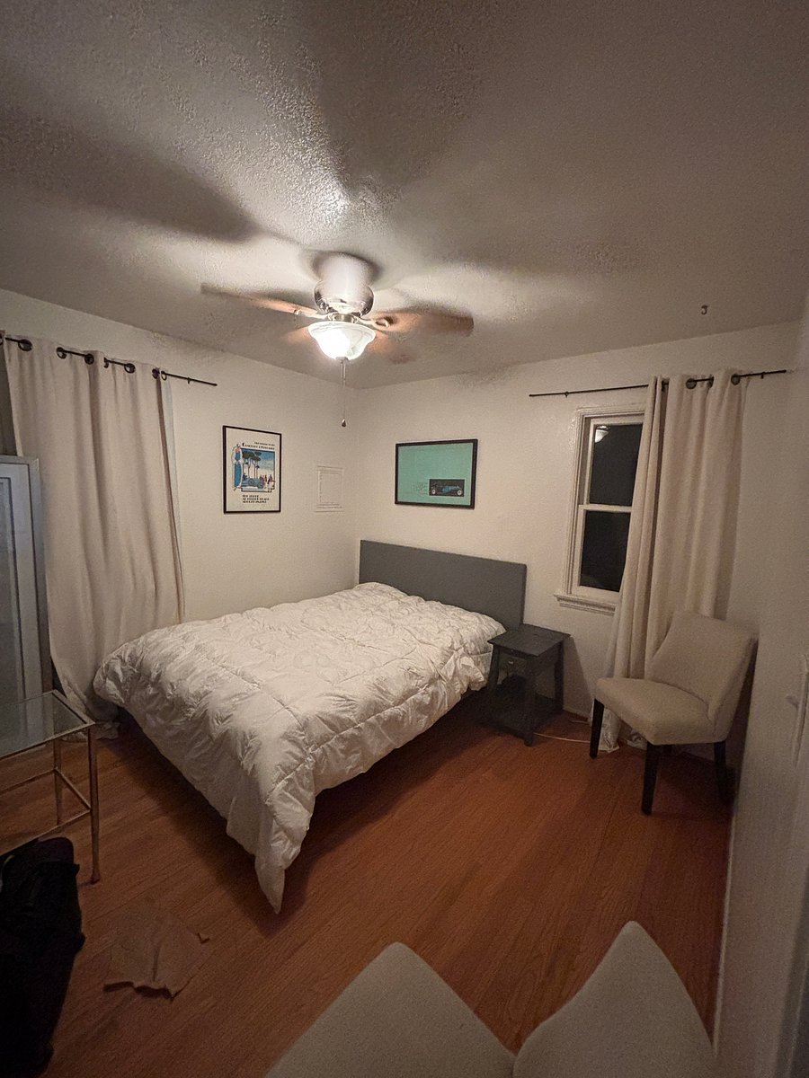 Bedroom with queen bed, closet, built in drawers and dresser