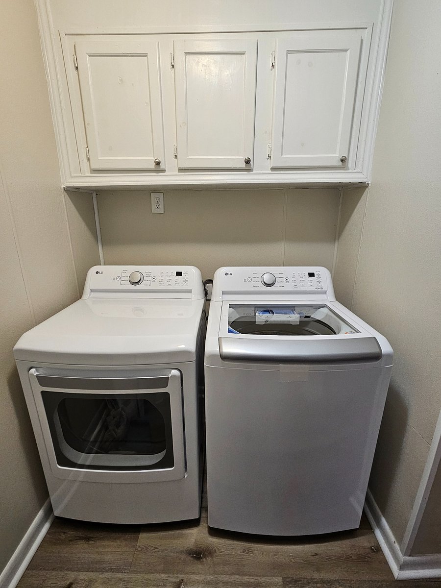 Laundry Area with Iron Board, Iron, Mop, and Broom