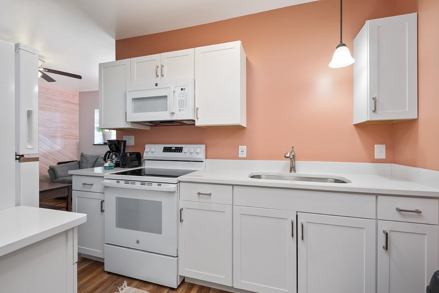 Kitchen with stove, fridge and microwave