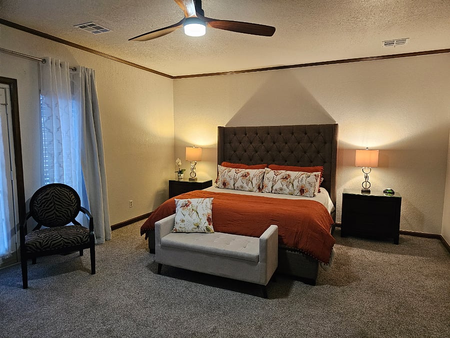 Master Bedroom with king size bed with elevated bed frame..