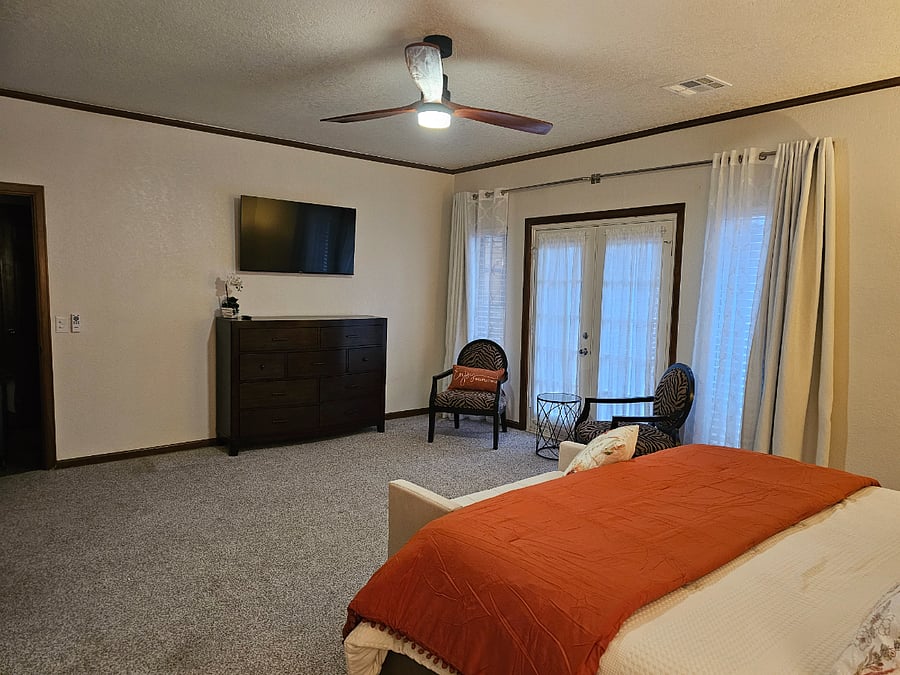 Master Bedroom with sitting area and French doors that leads to private patio..