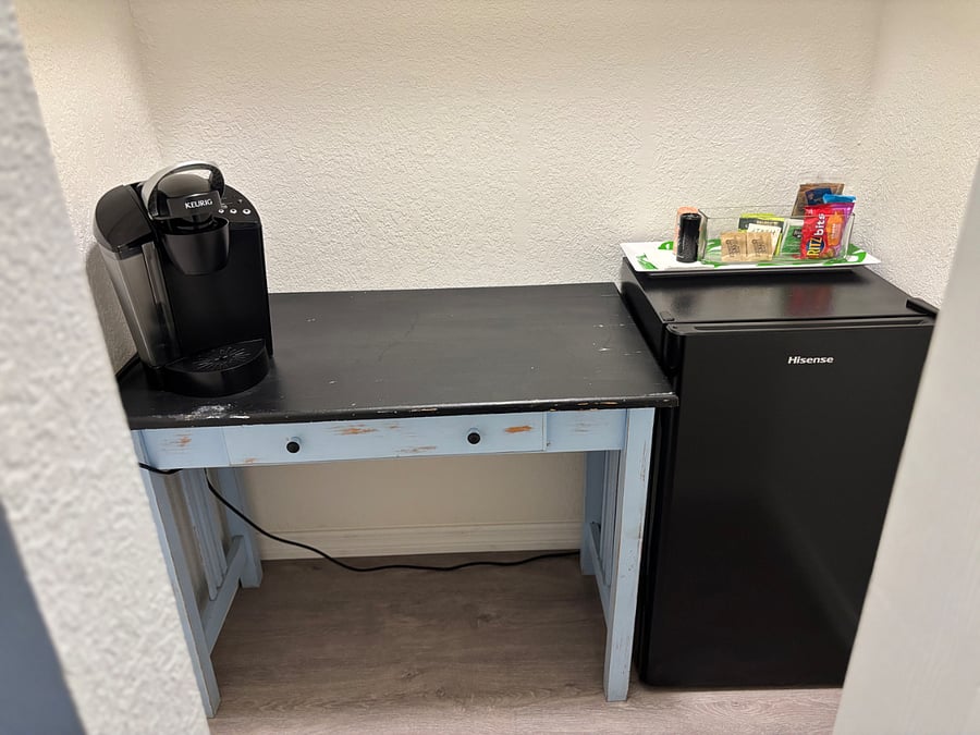 Small closet in master bedroom has a half fridge and keurig for use.