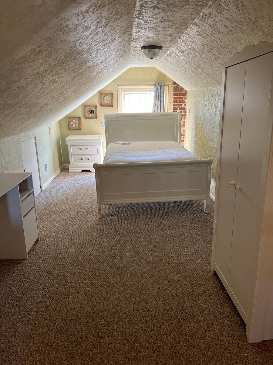Full sized bed in attic bedroom