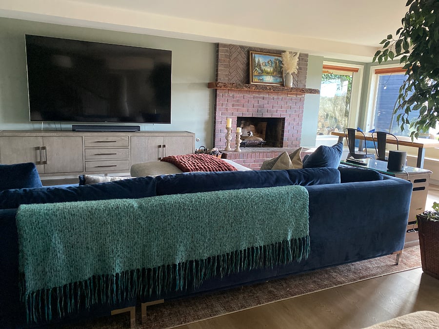 Living room opens to the dining area, kitchenette, and large picture windows.