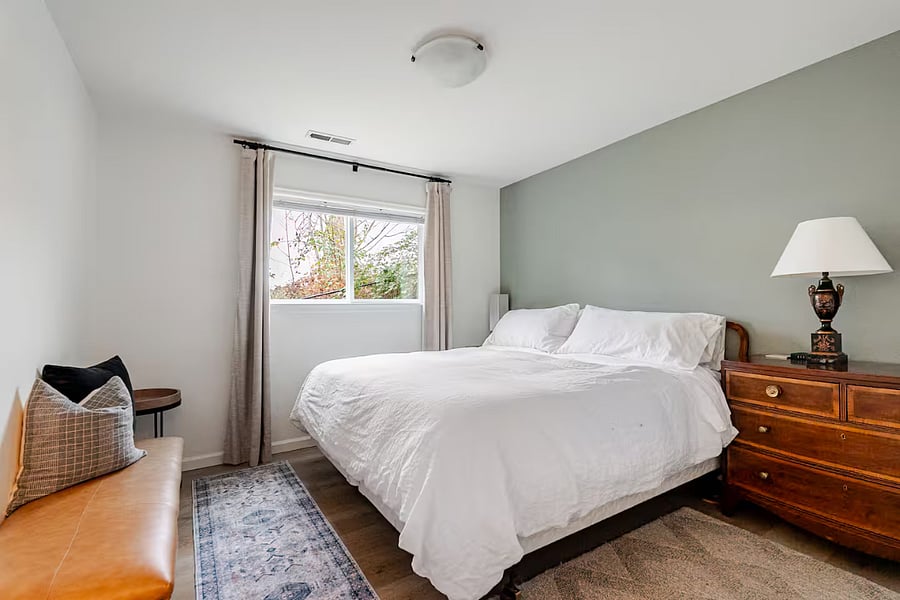Bedroom featuring luxury quality King bed, 640-thread-count linens, and blackout curtains. The bathroom is right beside the bedroom.