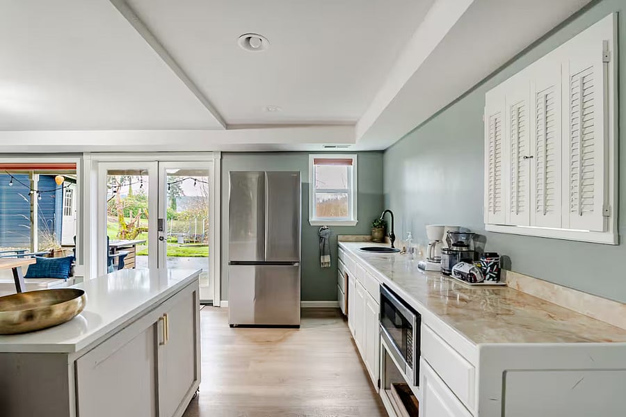 Kitchenette includes a full-size fridge, bar sink, microwave, coffee maker, coffee grinder, with plenty of counter space and storage. Additional kitchen amenities are available upon request (ie: air-fryer, hot plate, outdoor BBQ grill).