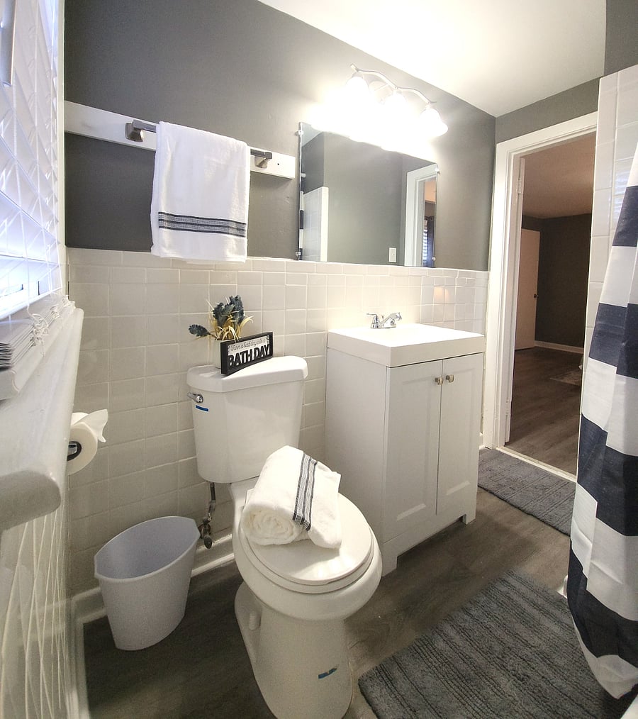Bathroom with full-sized bathtub & shower. Bathroom linens (towels, mats, etc.) and accessories are included.