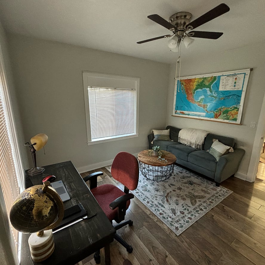 second room with workstation and sofa