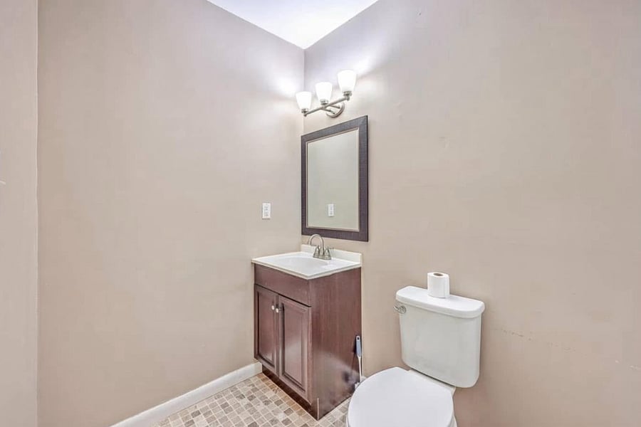 Relax in your own private bathroom, complete with a stand-up shower, a convenient rolling hanging rack (not pictured), and shelves stocked with towels and essential starter amenities!