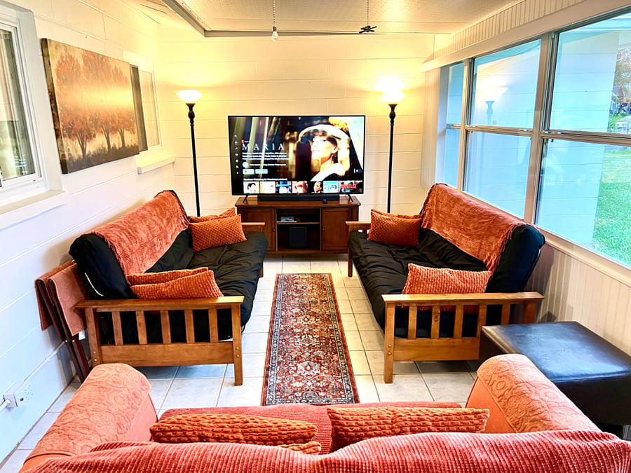 Large back porch with TV viewing area.