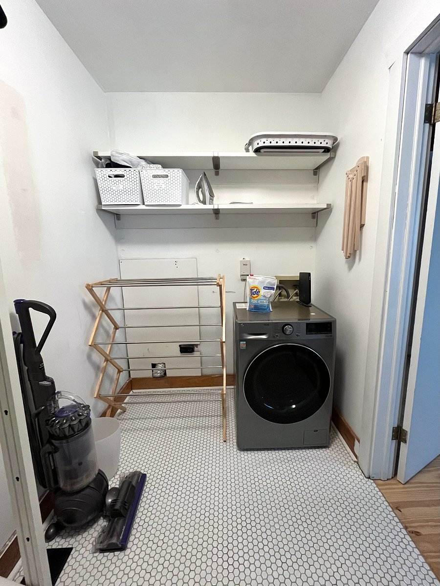 Closet with washer/dryer combo unit is attached to the downstairs bedroom.