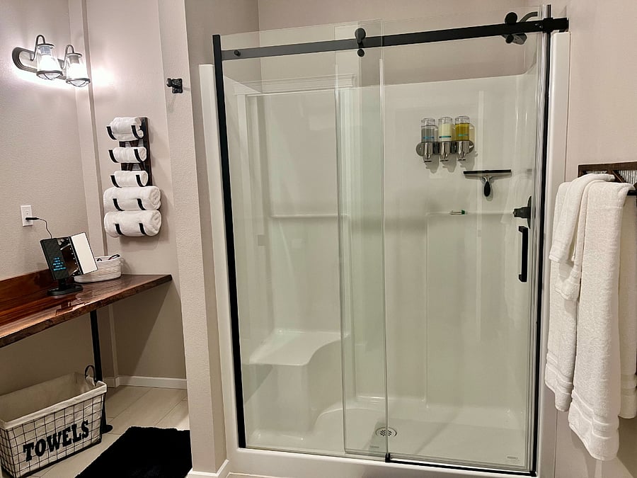 Bathroom including 5' shower with seat- shampoo, conditioner and soap supplied