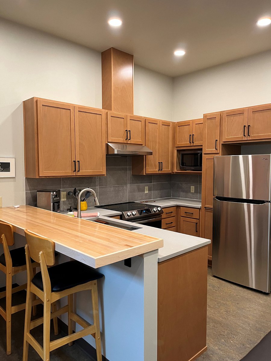 Spacious kitchen and counter with stools