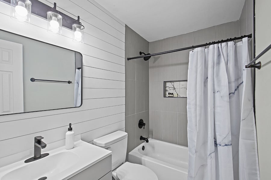 Full bath with bathtub - located off the hallway. 