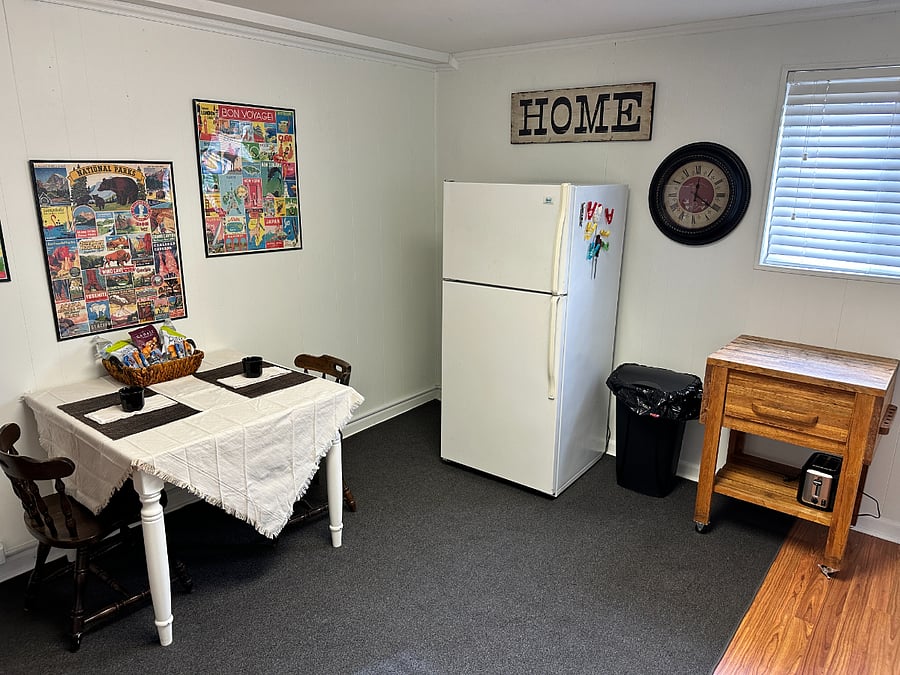Kitchen eating area, full fridge, mobile island.