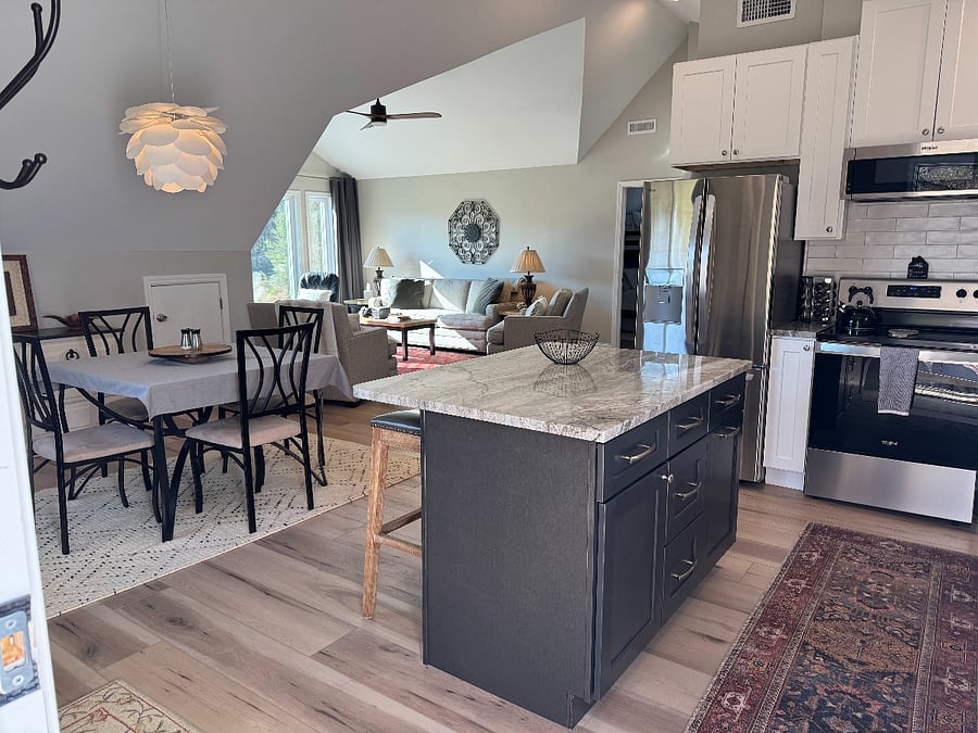 Large kitchen with island and four seat dining table.