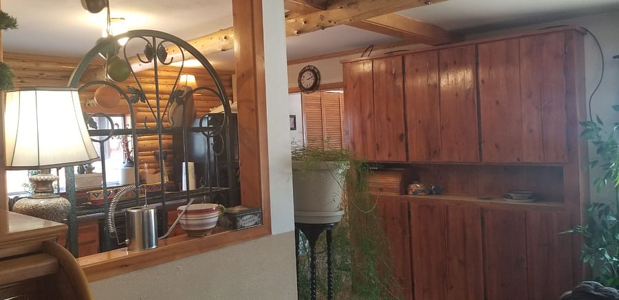 view from den/ding of Custom Cabinets and part of kitchen and entrance to entry rm and wood stove