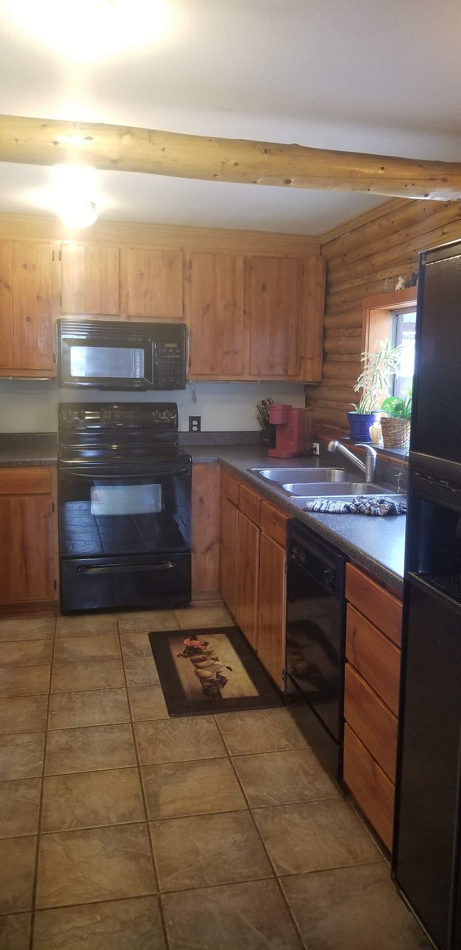 3/4ths of Kitchen view. Micro and bakers rack to left and Massive Storage behind camera.