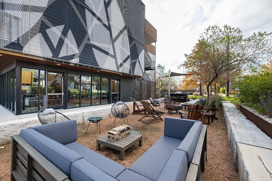 Outdoor common area, and comfy shared, indoor space in the background.