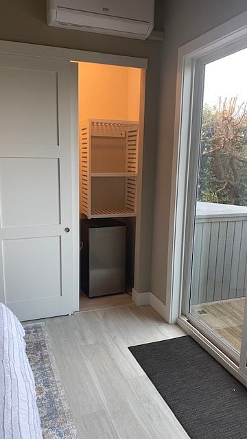 Beach room closet with mini fridge and custom shelving