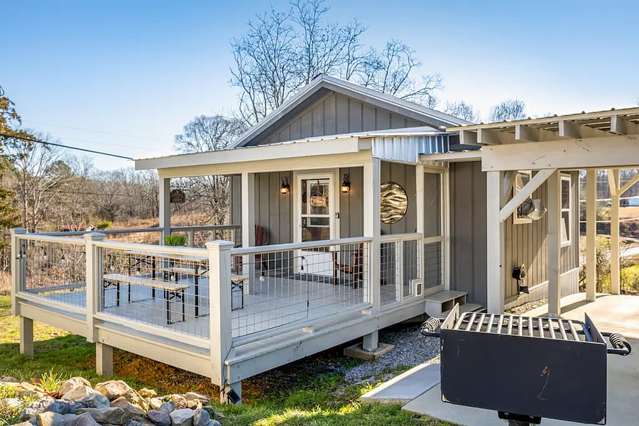Cook a delicious meal on the charcoal grill, and then sit down to enjoy it on the front porch picnic table