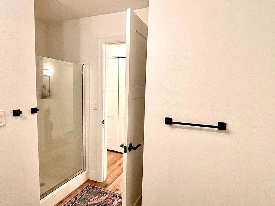 Thoughtfully illuminated and impeccably designed, this bathroom combines clean, minimalist aesthetics with a warm and inviting atmosphere, offering the perfect retreat for relaxation and rejuvenation. *Excellent water pressure in the shower***