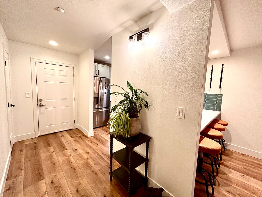 The pathway effortlessly guides you toward the cozy sanctuary of the condo, ensuring a seamless transition between functionality and relaxation in this beautifully designed home.